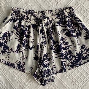 White shorts with purple design, size medium